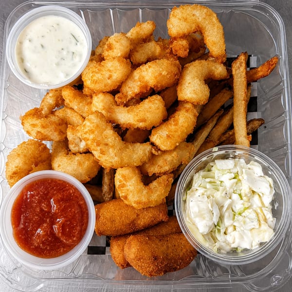 Fried shrimp, french fries, and hush puppies with tartar sauce, cocktail sauce, and coleslaw.